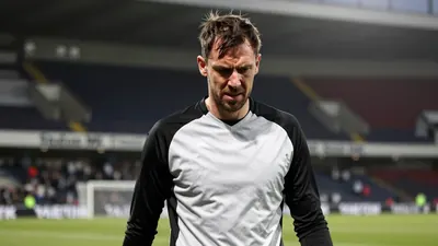 Milton Keynes Dons' Craig MacGillivray makes a crucial save to deny Huddersfield a second goal, earning his team a 1-1 draw
